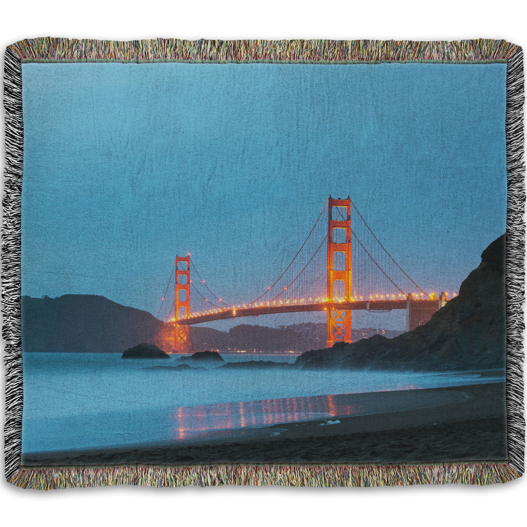 A woven throw blanket designed with a photo from Baker Beach, San Francisco, looking out over the water at the Golden Gate Bridge.