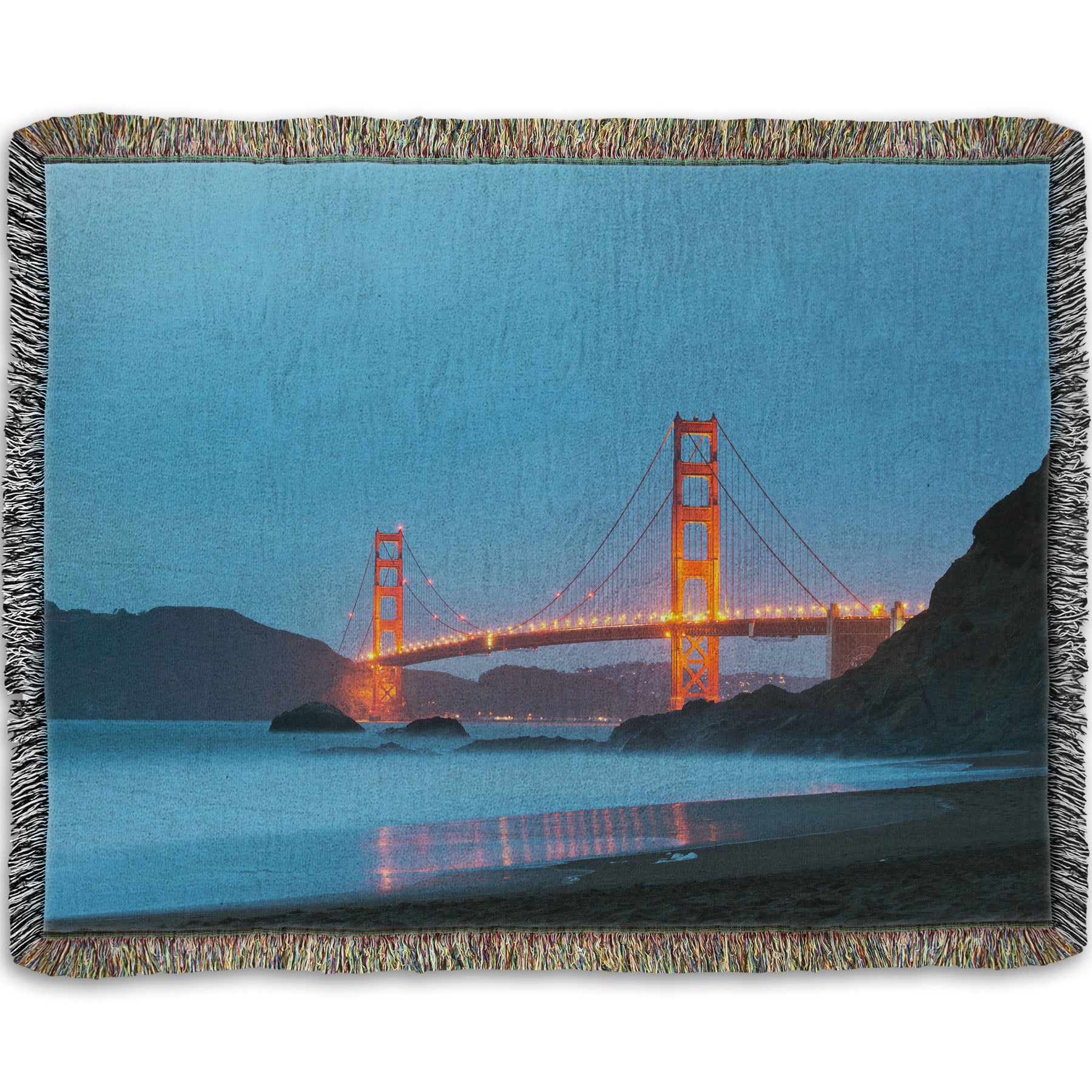 A woven throw blanket designed with a photo from Baker Beach, San Francisco, looking out over the water at the Golden Gate Bridge.