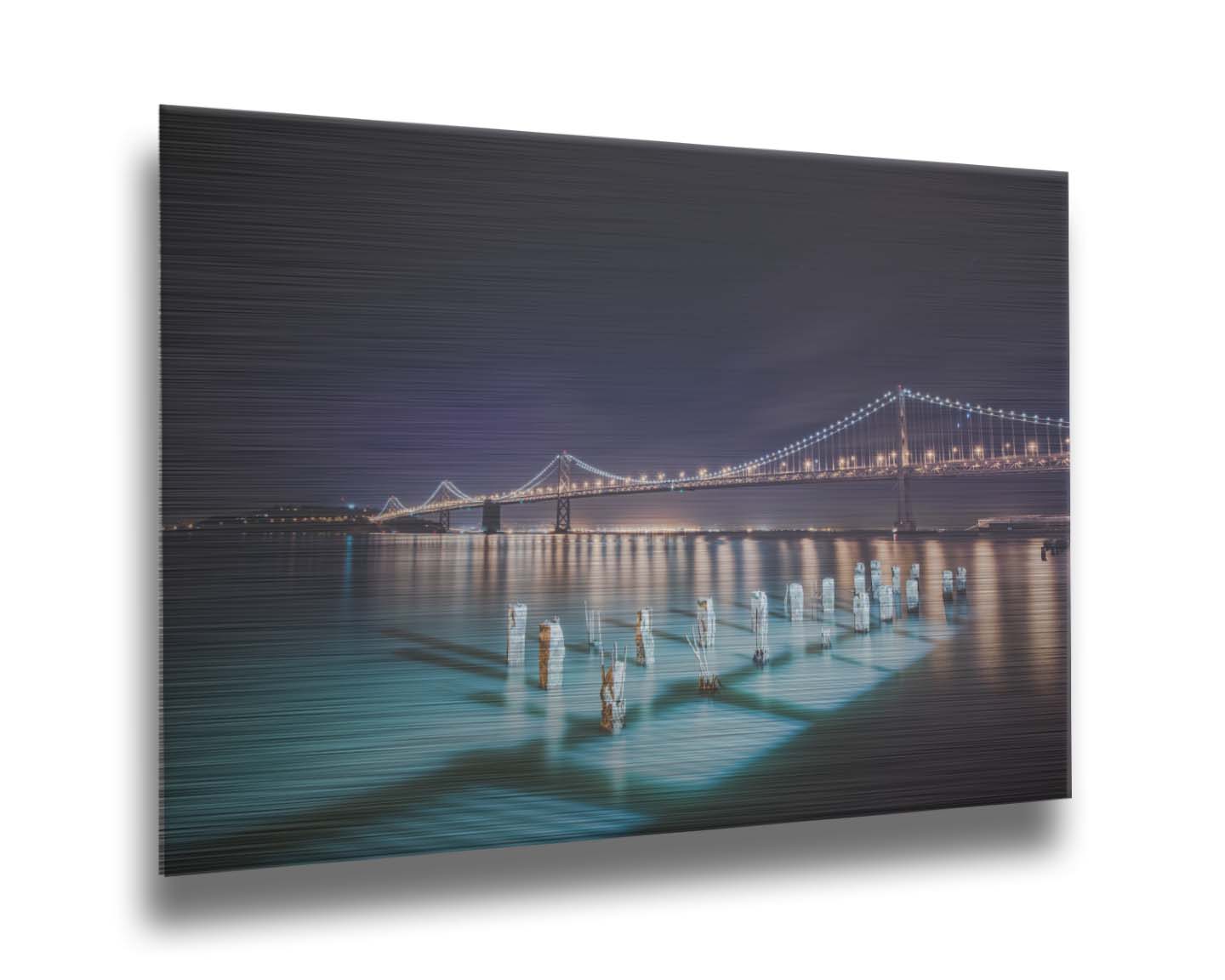 Photo of the Oakland Bay Bridge in San Francisco at night, taken from the Embarcadaro. Printed on metal.