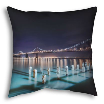 A throw pillow designed with a photo of the Oakland Bay Bridge in San Francisco at night, taken from the Embarcadero.