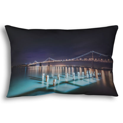 A throw pillow designed with a photo of the Oakland Bay Bridge in San Francisco at night, taken from the Embarcadero.