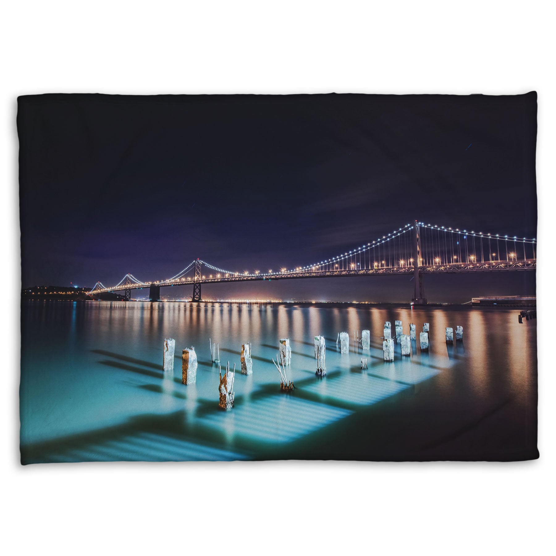 A coral fleece blanket designed with a photo of the Oakland Bay Bridge in San Francisco at night, taken from the Embarcadero.