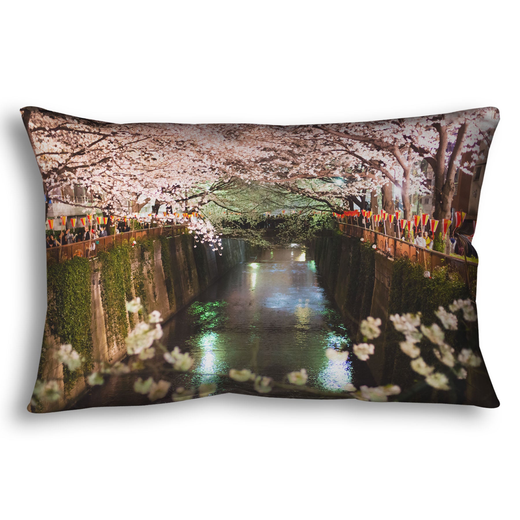 A throw pillow designed with a photo of cherry blossom trees over a canal at Meguro River in Tokyo, Japan.