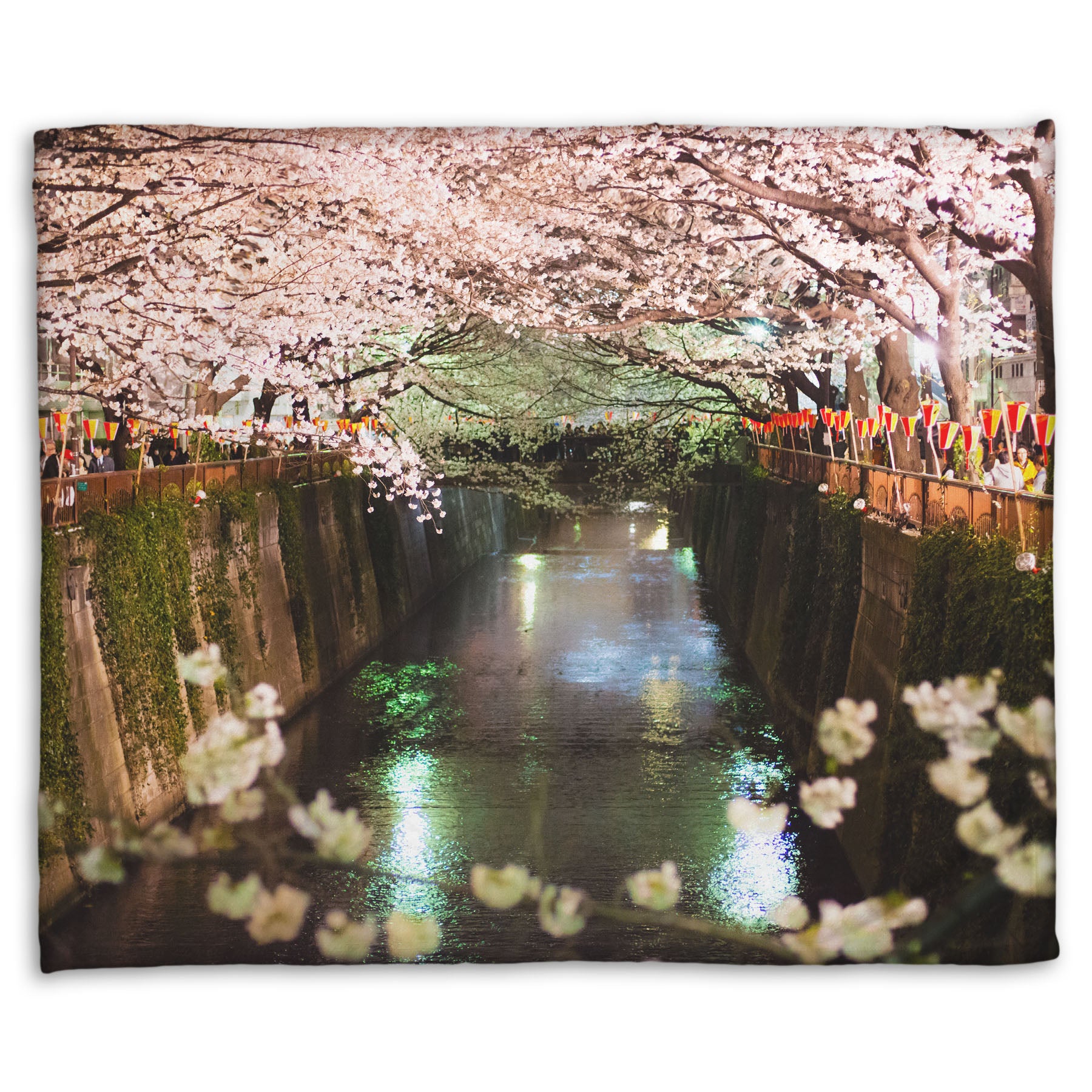 A coral fleece blanket designed with a photo of cherry blossom trees over a canal at Meguro River in Tokyo, Japan.