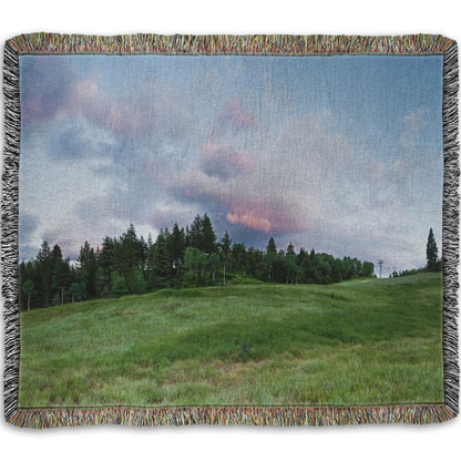 A woven throw blanket designed with a photo of the hills and sky at Sundance in Utah, at the Provo Canyon by Mount Timpanogos.