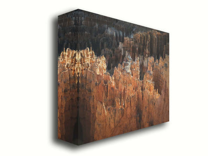 A photo of hoodoo rock formations, jagged stone spires formed by the erosion of a plateau, in Bryce Canyon National Park from a high angle. Printed on canvas.