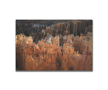 A photo of hoodoo rock formations, jagged stone spires formed by the erosion of a plateau, in Bryce Canyon National Park from a high angle. Printed on a box board.