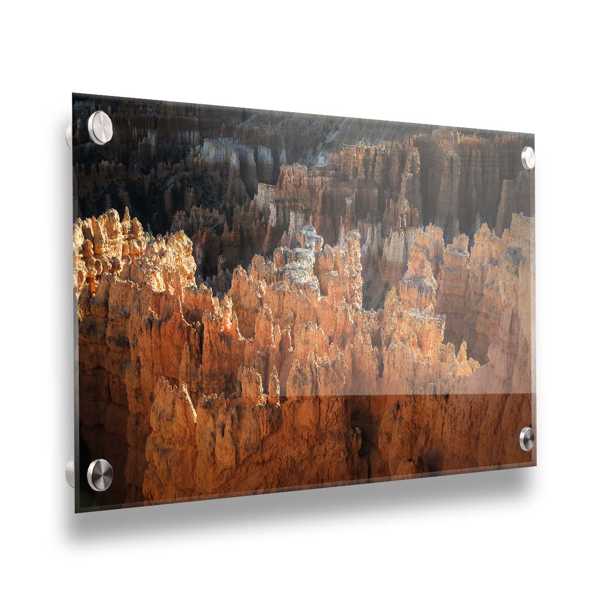 A photo of hoodoo rock formations, jagged stone spires formed by the erosion of a plateau, in Bryce Canyon National Park from a high angle. Printed on acrylic.