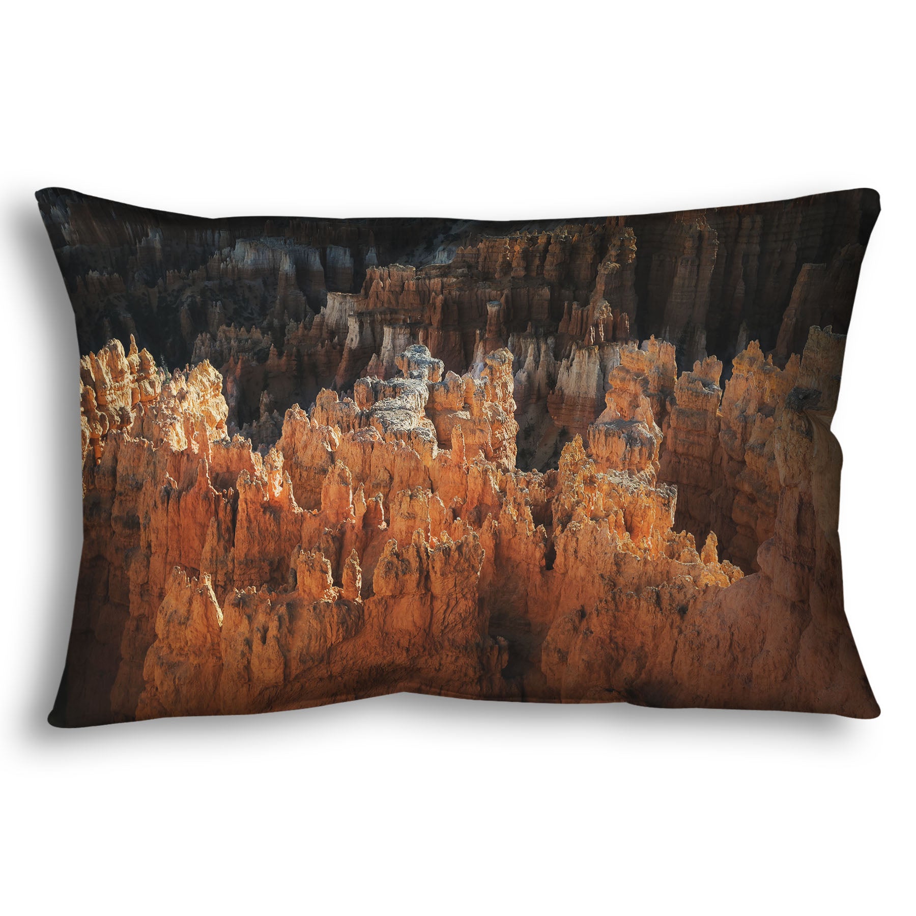 A throw pillow designed with a photo of hoodoo rock formations, jagged stone spires formed by the erosion of a plateau, in Bryce Canyon National Park from a high angle.