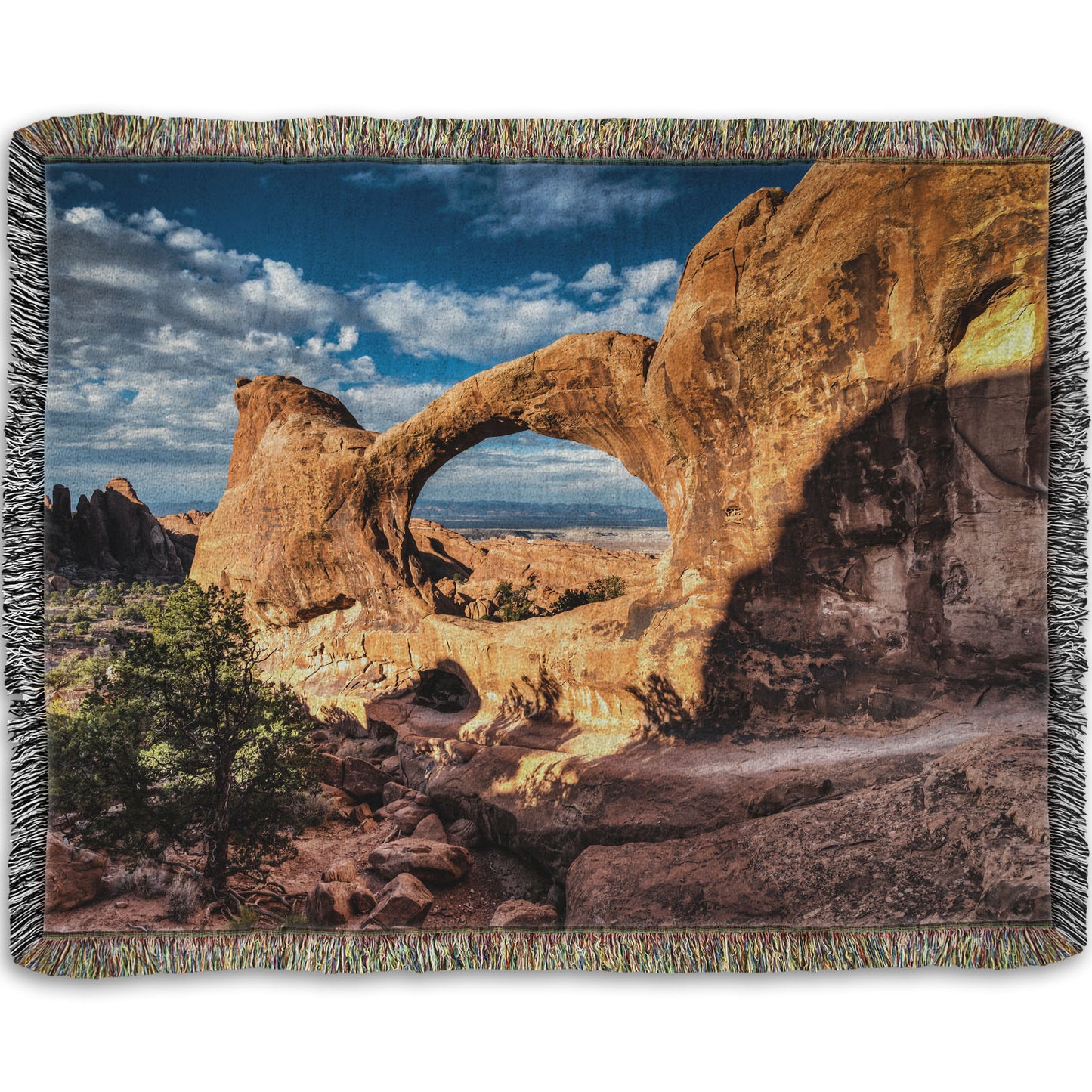 Woven throw blanket designed with a photo of the Double O arch in the Devil's Garden at Arches National Park, Utah. The rocky arch is set against a bright blue sky.