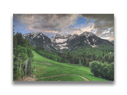 Photo of snowcapped mountains and rolling green hills and forestry, at the Sundance Ski Resort in Utah. Printed on canvas.