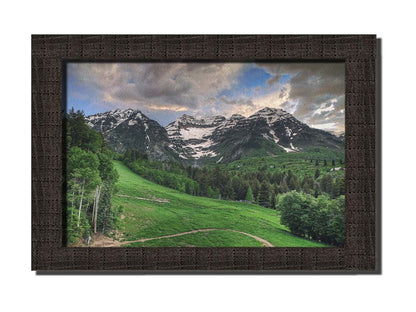 Photo of snowcapped mountains and rolling green hills and forestry, at the Sundance Ski Resort in Utah. Printed on canvas and framed.