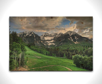 Photo of snowcapped mountains and rolling green hills and forestry, at the Sundance Ski Resort in Utah. Printed on a wood pallet.