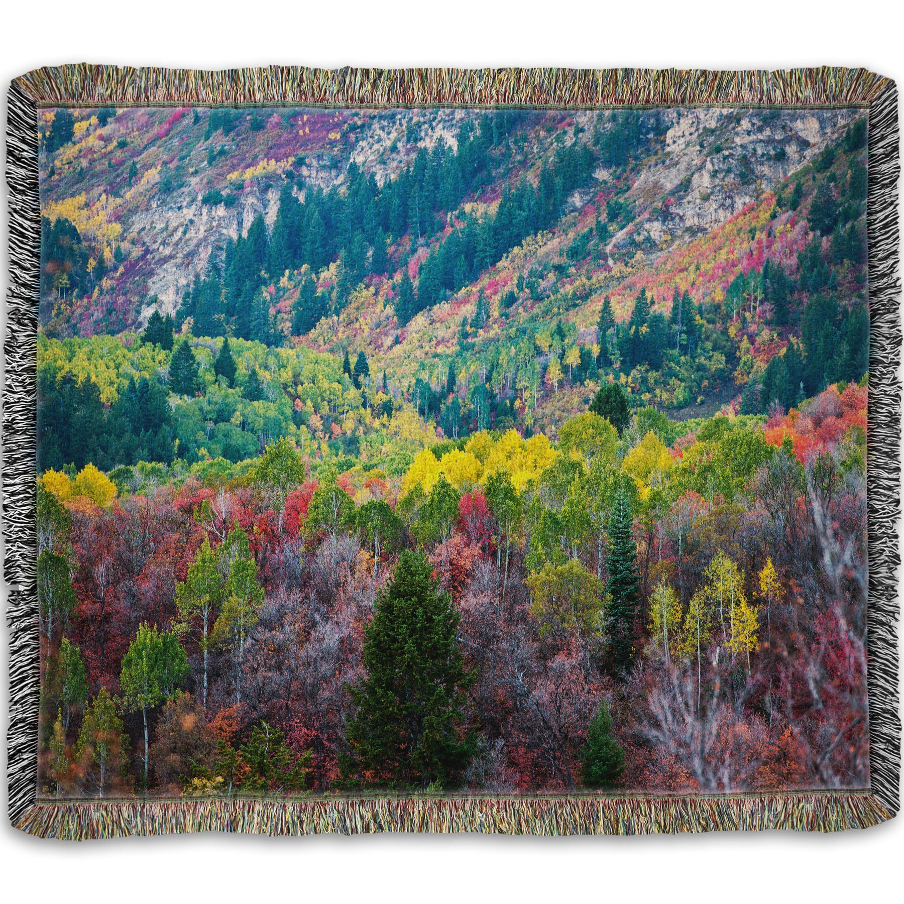 A woven throw blanket designed with a photo looking down on a forest at the Sundance Mountain Resort in Utah. The trees are changing colors, ranging from green, yellow, and red to no leaves at all.