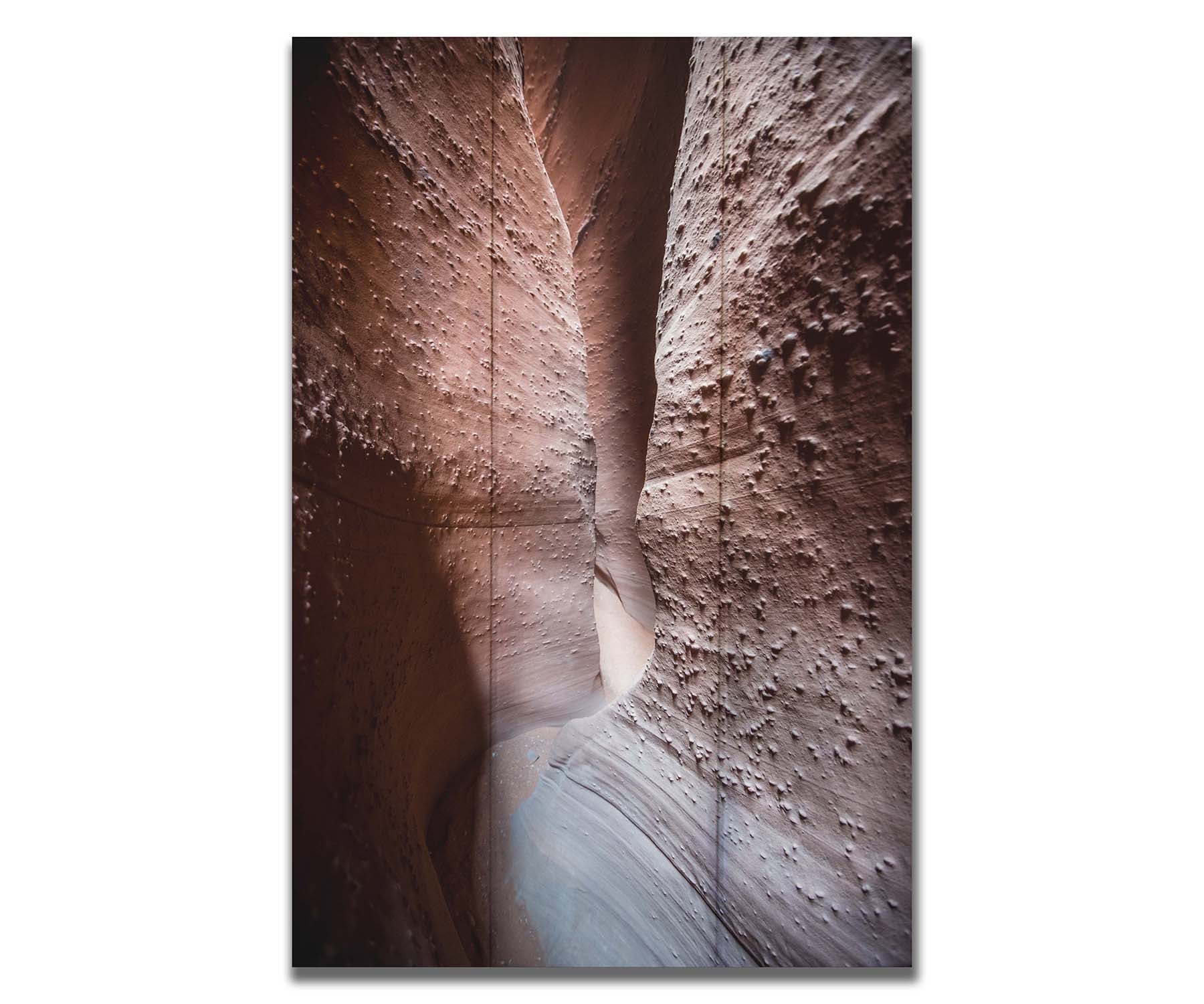 A photo of the slot canyon called Spooky near Escalante, Utah. It features a narrow crevice of lrough and smooth layers of stone. Printed on a box board.