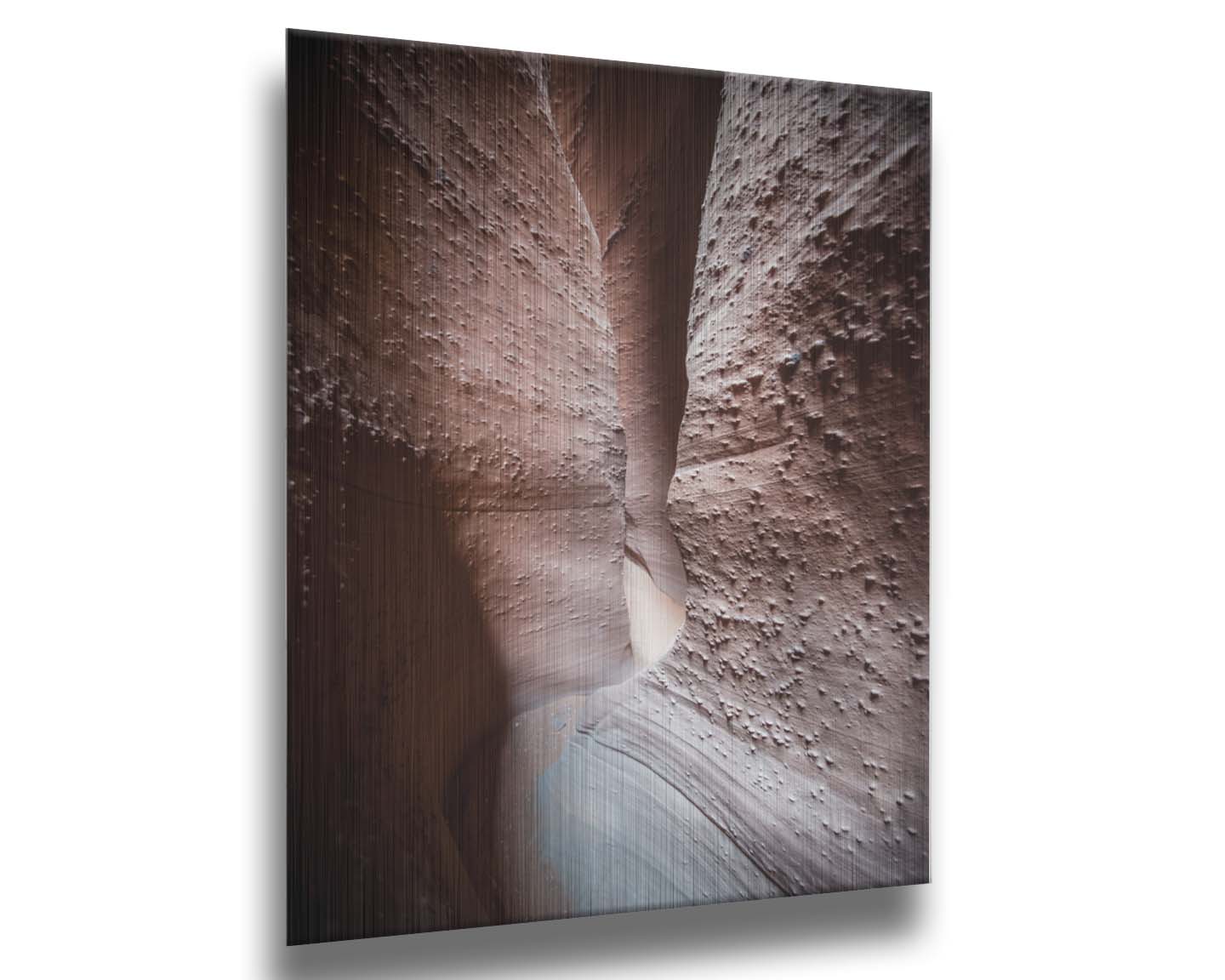 A photo of the slot canyon called Spooky near Escalante, Utah. It features a narrow crevice of lrough and smooth layers of stone. Printed on metal.