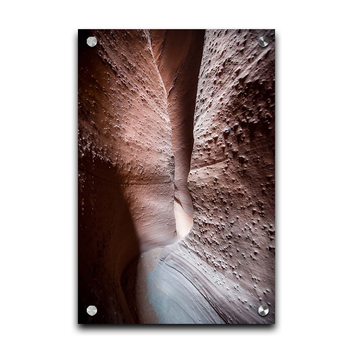 A photo of the slot canyon called Spooky near Escalante, Utah. It features a narrow crevice of lrough and smooth layers of stone. Printed on acrylic.