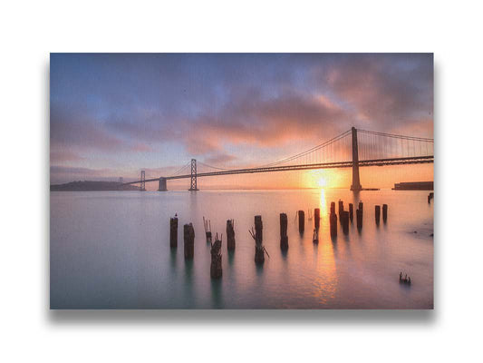 Photo of the Oakland Bay Bridge in San Francisco at sunrise, taken from the Embarcadaro. Printed on canvas.