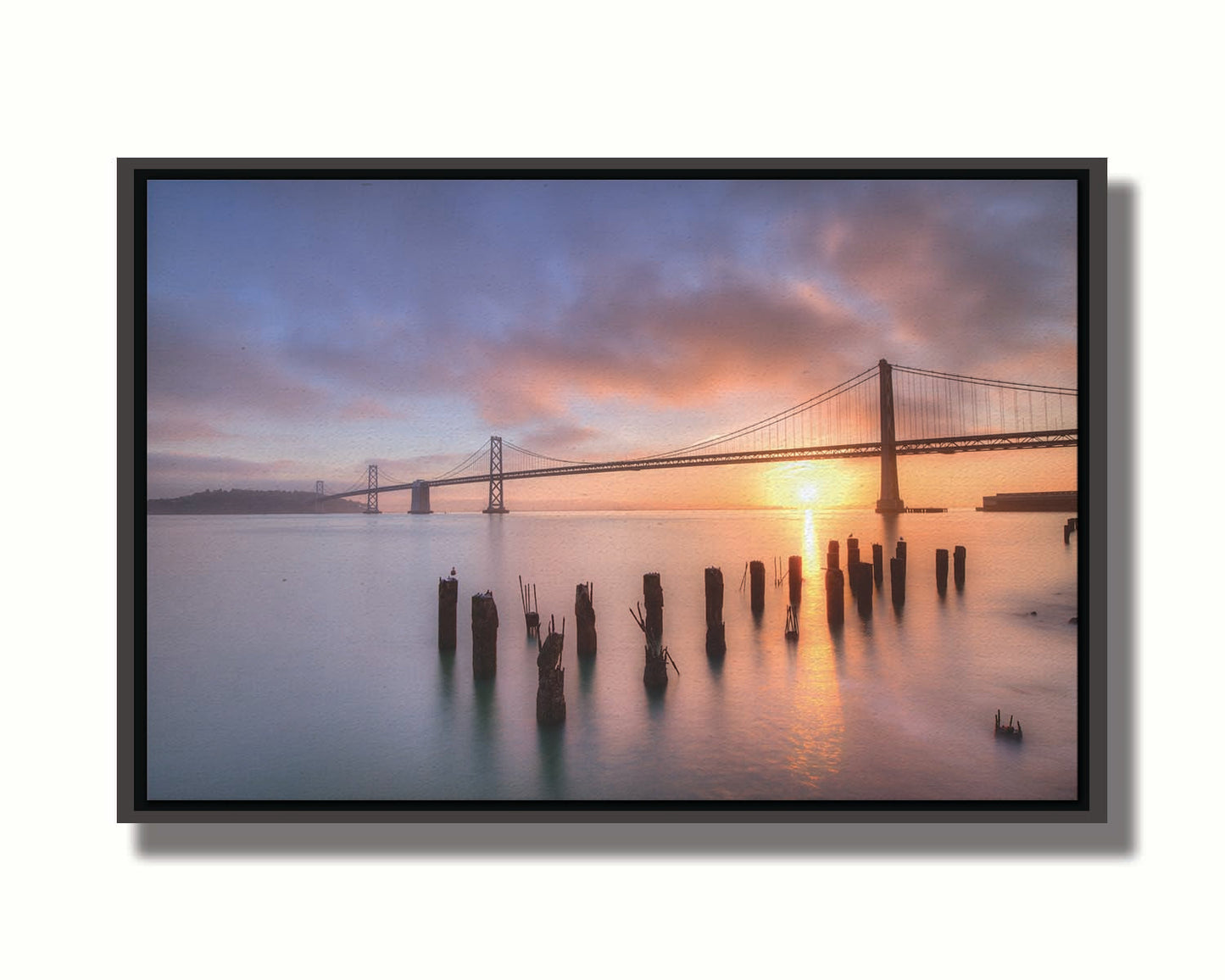 Photo of the Oakland Bay Bridge in San Francisco at sunrise, taken from the Embarcadaro. Printed on canvas in a float frame.