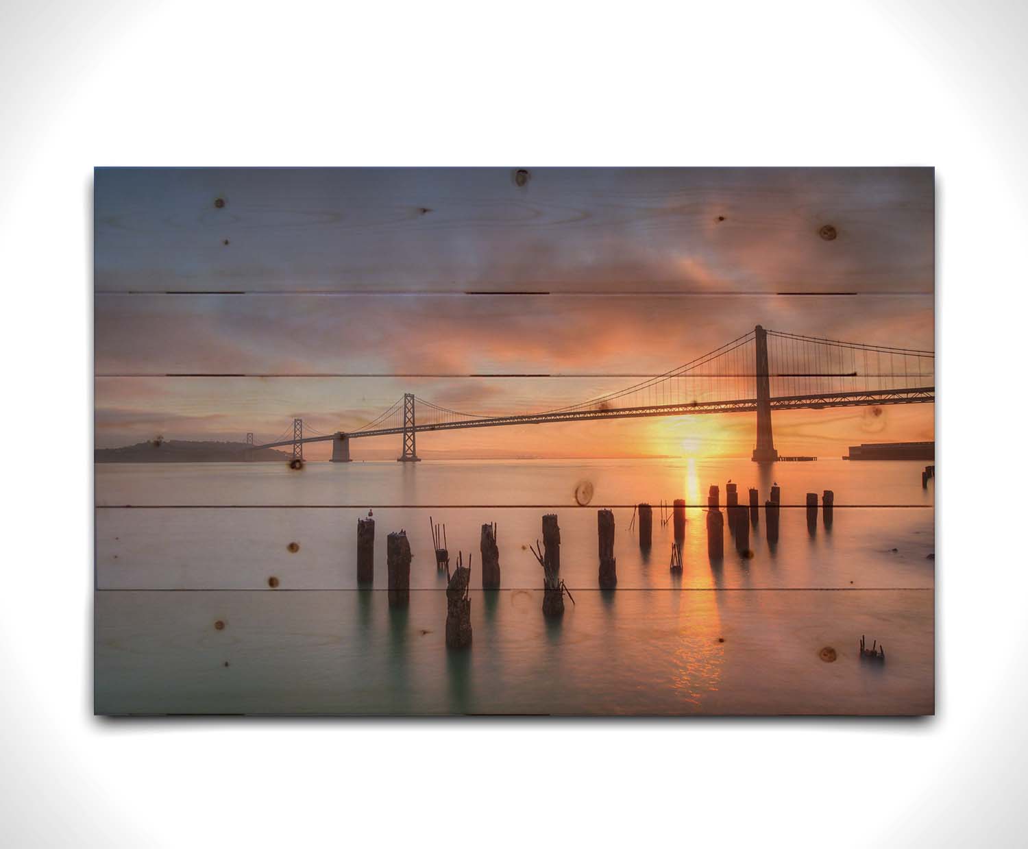 Photo of the Oakland Bay Bridge in San Francisco at sunrise, taken from the Embarcadaro. Printed on a wood pallet.