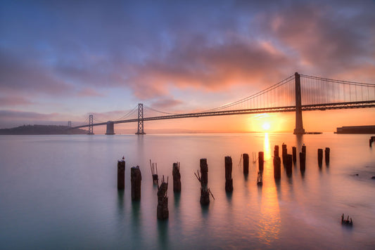 Photo of the Oakland Bay Bridge in San Francisco at sunrise, taken from the Embarcadaro.