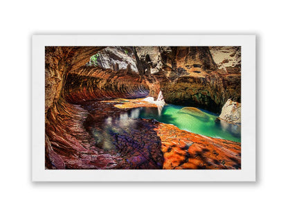 A photo from inside The Subway, or Left Fork of North Creek, at Zion National Park in Utah. It features a canyon of orange and red stone with a vibrant pool of green waters. Printed on canvas and framed.