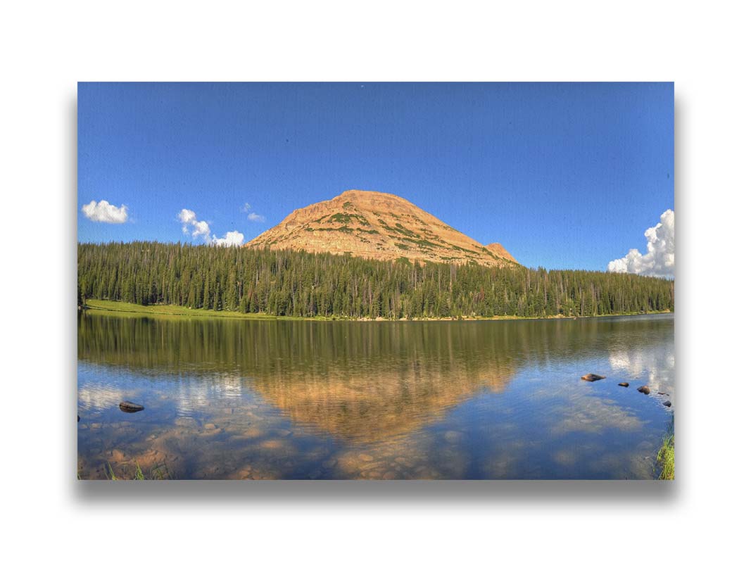 Photo of Mirror Lake in Utah. A mountain, forest, blue sky, and fluffy clouds are reflected on the lakewater. Printed on canvas.