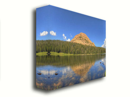 Photo of Mirror Lake in Utah. A mountain, forest, blue sky, and fluffy clouds are reflected on the lakewater. Printed on canvas.