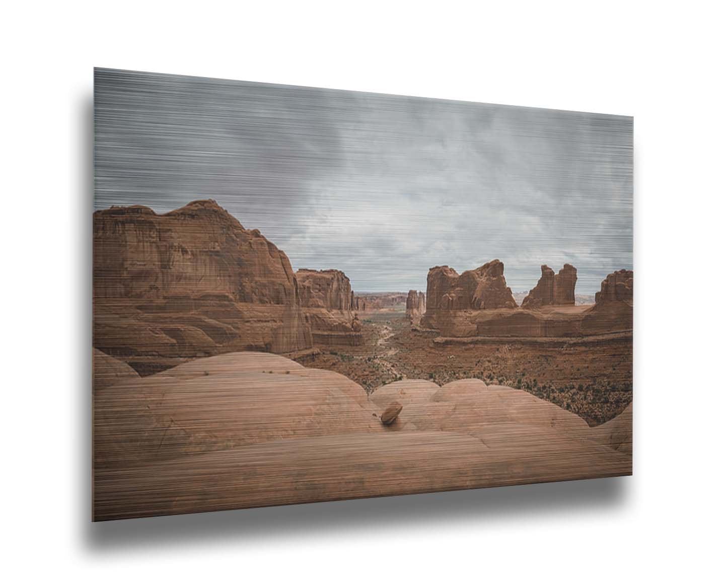 A photograph of Park Avenue at Arches National Park, looking out between rocky plateaus. Printed on metal.