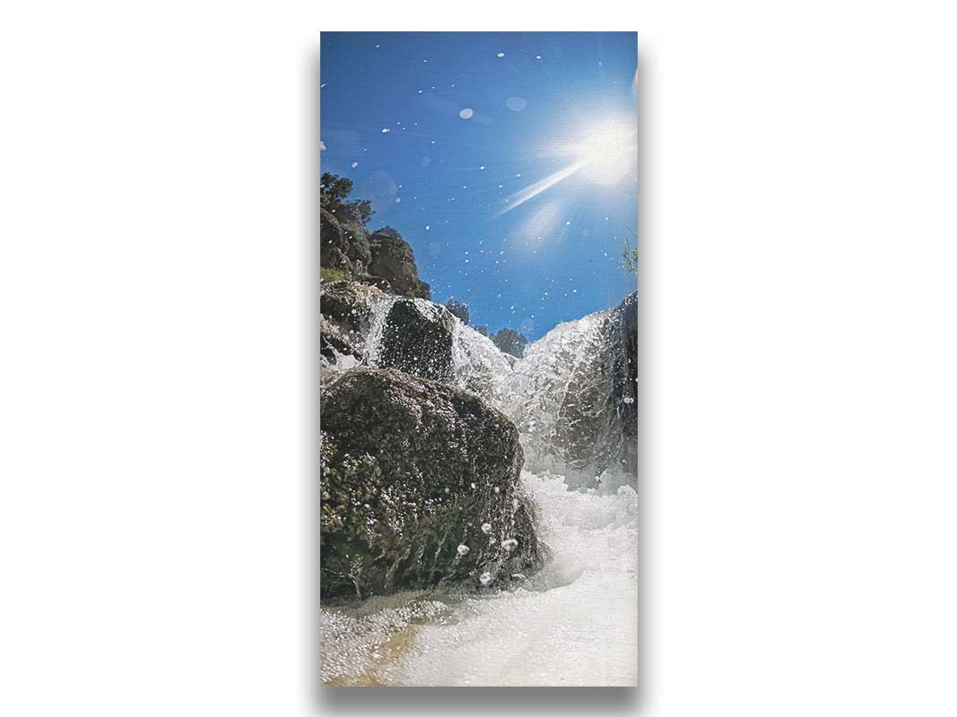 A photo looking up at the waterfalls filling the mountain hotsprings in Utah. The sky is clear and vibrant blue. Printed on canvas.