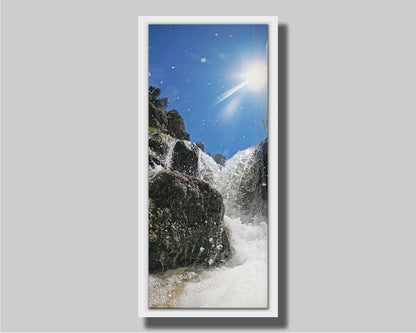 A photo looking up at the waterfalls filling the mountain hotsprings in Utah. The sky is clear and vibrant blue. Printed on canvas in a float frame.