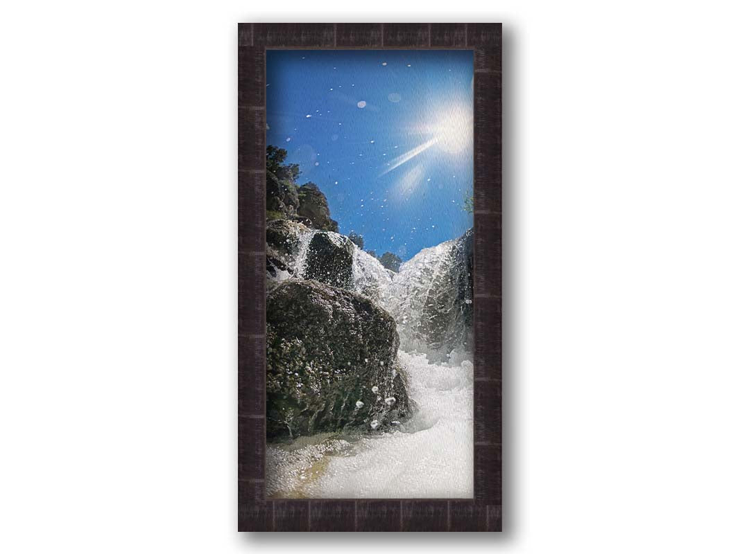 A photo looking up at the waterfalls filling the mountain hotsprings in Utah. The sky is clear and vibrant blue. Printed on canvas and framed.