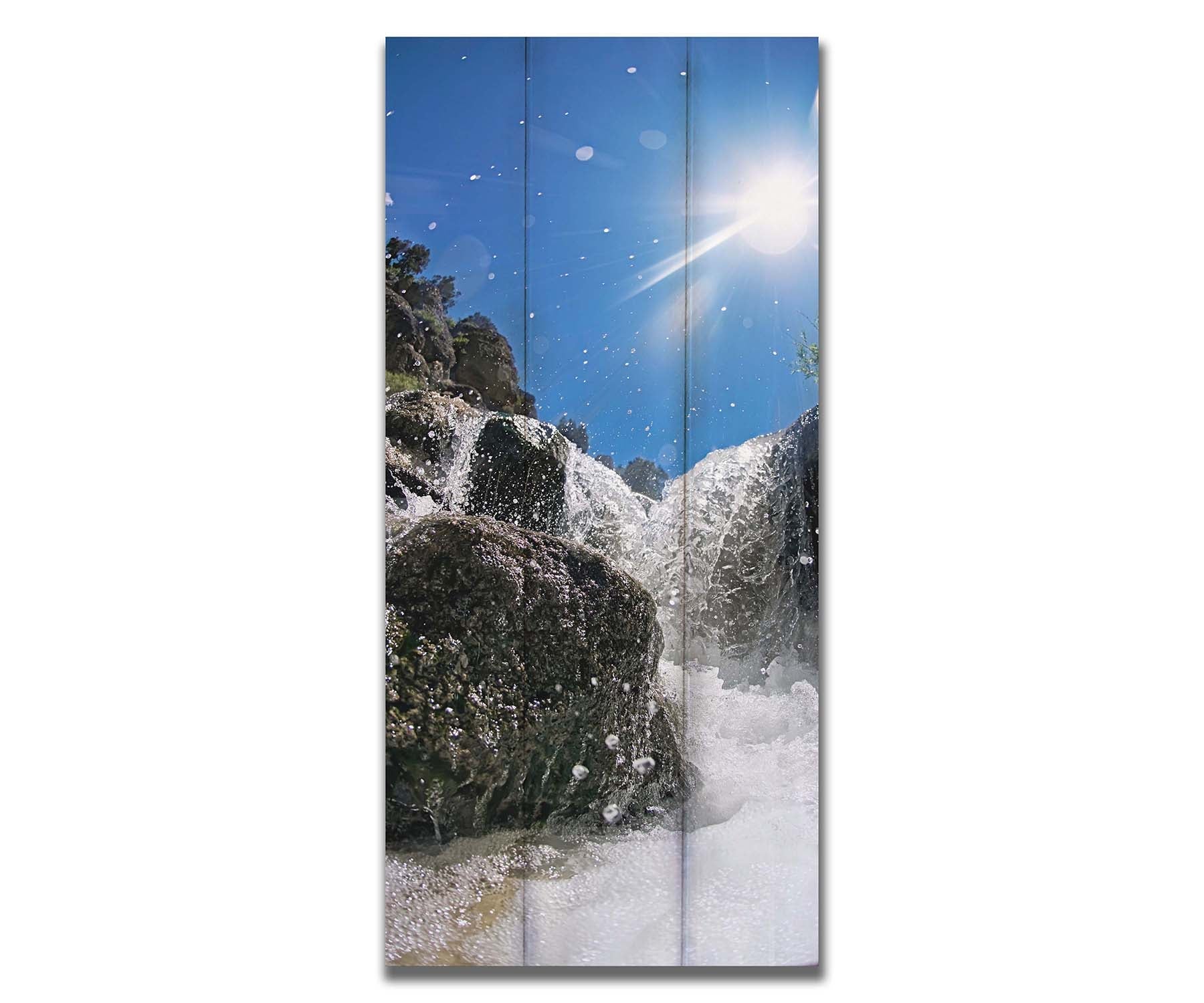 A photo looking up at the waterfalls filling the mountain hotsprings in Utah. The sky is clear and vibrant blue. Printed on a box board.