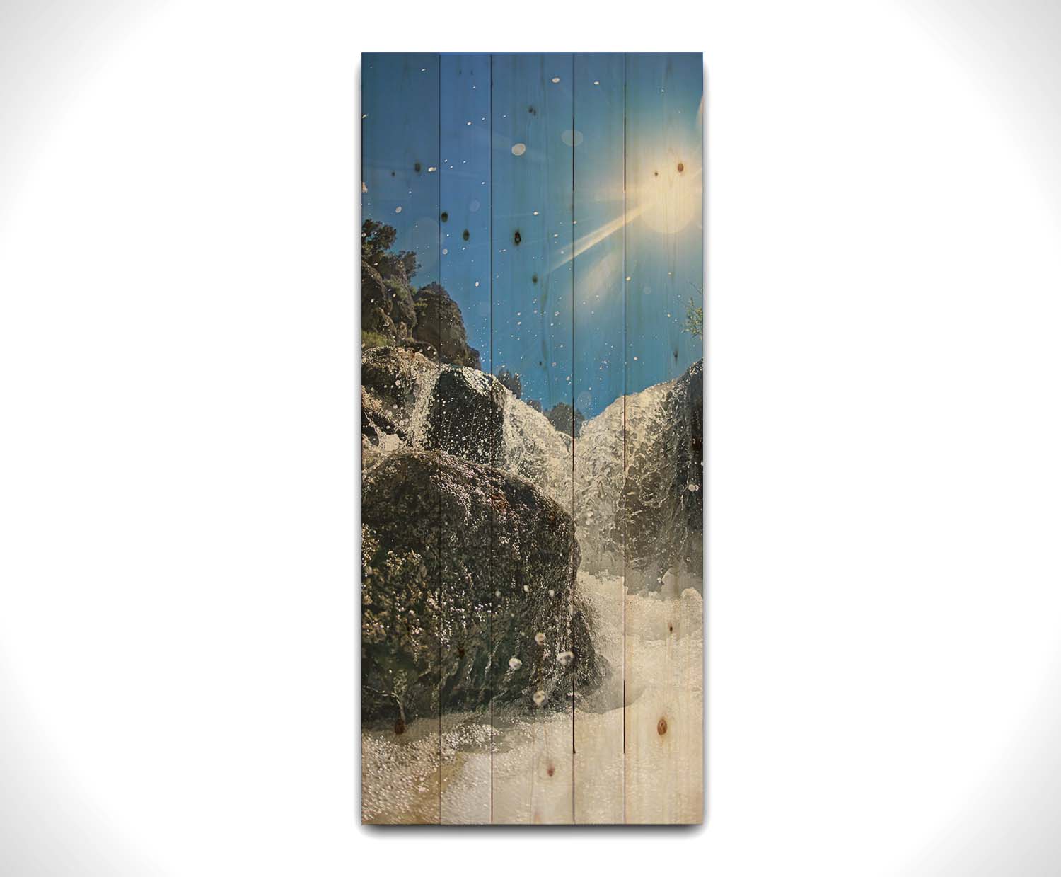 A photo looking up at the waterfalls filling the mountain hotsprings in Utah. The sky is clear and vibrant blue. Printed on a wood pallet.