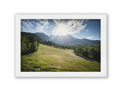 A photo of the sun shining brightly over Mount Timpanogos. The hillsides and forest are the fresh green of springtime. Printed on canvas and framed.