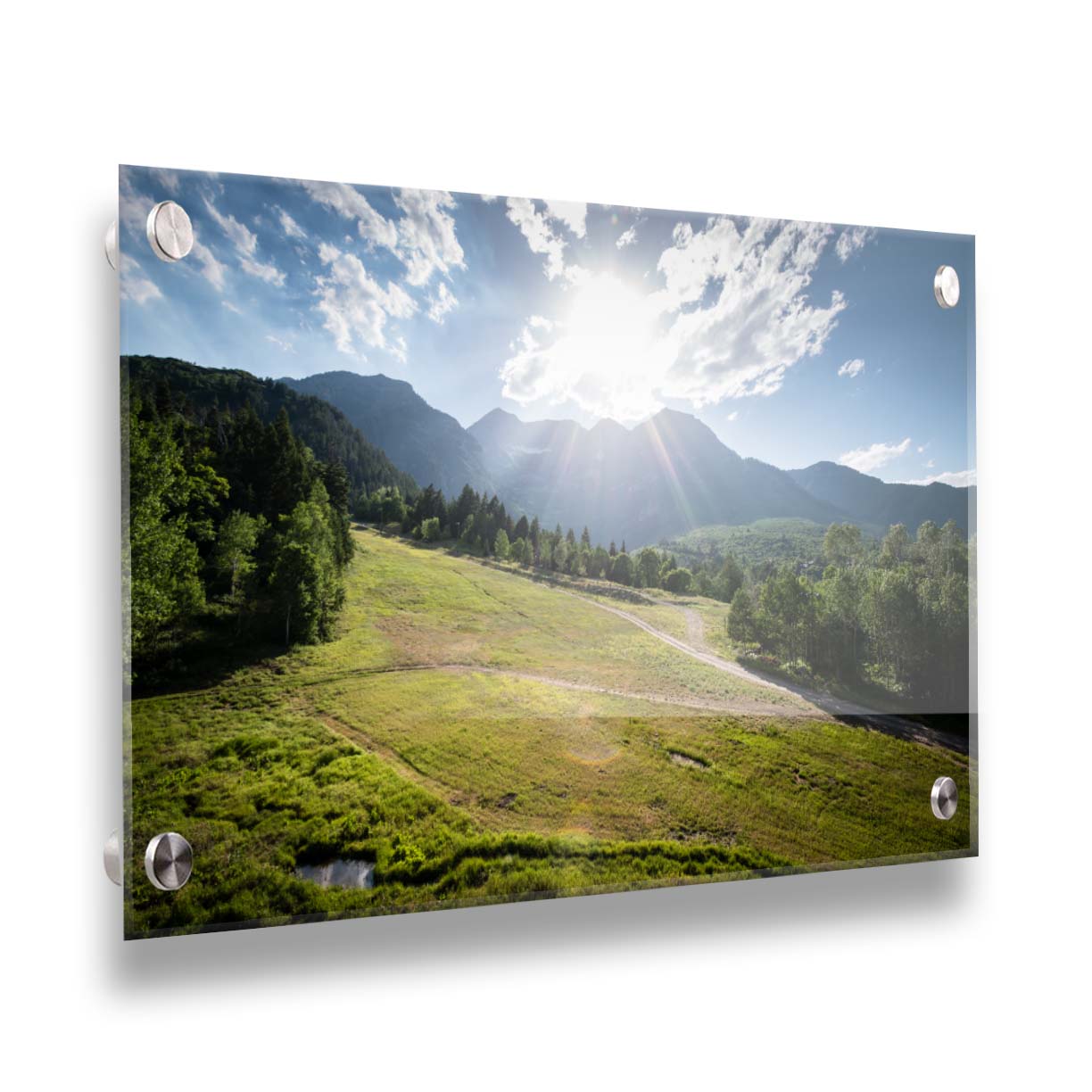 A photo of the sun shining brightly over Mount Timpanogos. The hillsides and forest are the fresh green of springtime. Printed on acrylic.