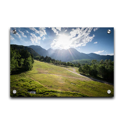 A photo of the sun shining brightly over Mount Timpanogos. The hillsides and forest are the fresh green of springtime. Printed on acrylic.