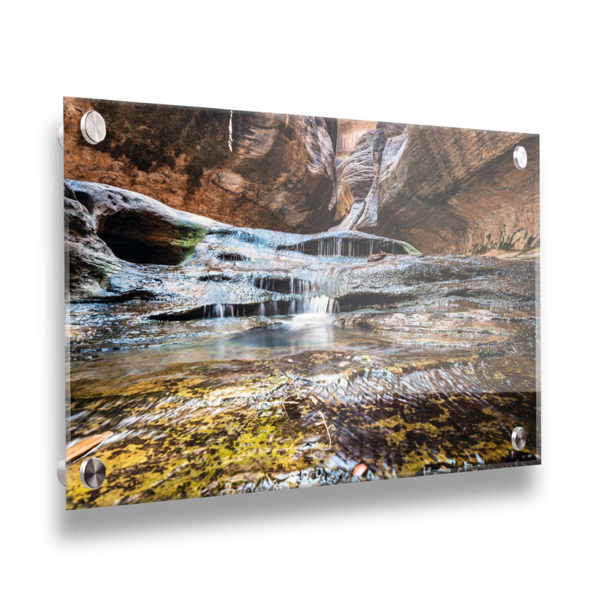 A photo of the Left Fork North Creek flowing through the Subway slot canyon in Utah's Zion National Park. It flows toward the camera, tumbling over slabs in the sandstone to create small waterfalls. Printed on acrylic.