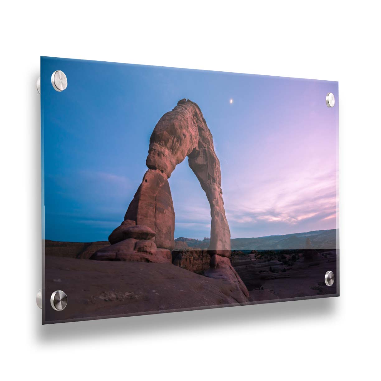 A photo of the Delicate Arch rock formation in Arches National Park, Utah. The blues and purples of the sky at sunset compliment the oranges and browns of the sandstone arch. Printed on acrylic.