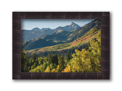 A photo overlooking the Aspen Grove and Cascade Mountain from Sundance Resort in Utah. The trees of Aspen Grove are a mix of deep evergreens and yellow fall aspens. The snow-dusted Cascade Mountain sits in the back, toned blue by atmospheric perspective. Printed on canvas and framed.