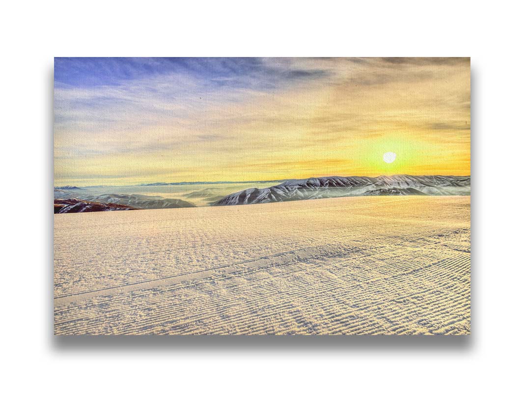 A photo of the sunrise over Sundance Ski Resort. The sun creates a yellow reflective glow on the freshly groomed ski slope. Printed on canvas.