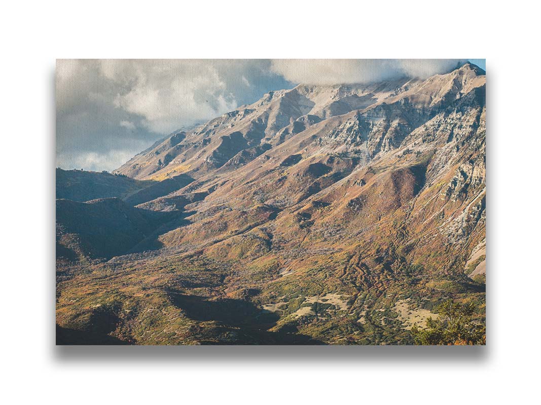 A photo of Mount Timpanogos during the fall. Taken from Piestewa Peak, this photo looks down across groves of trees turning color, appearing small from the altitude. Printed on canvas.