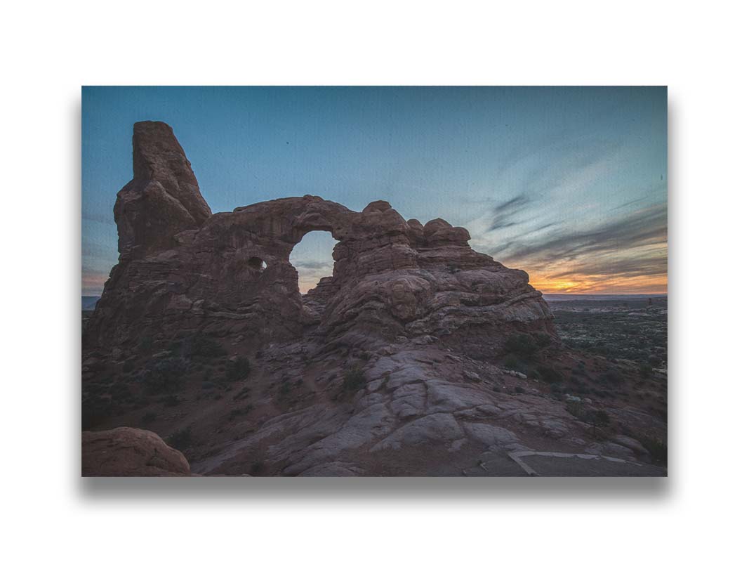 A photo of the Turret Arch rock formation at Arches National Park, Utah during sunset. Printed on canvas.