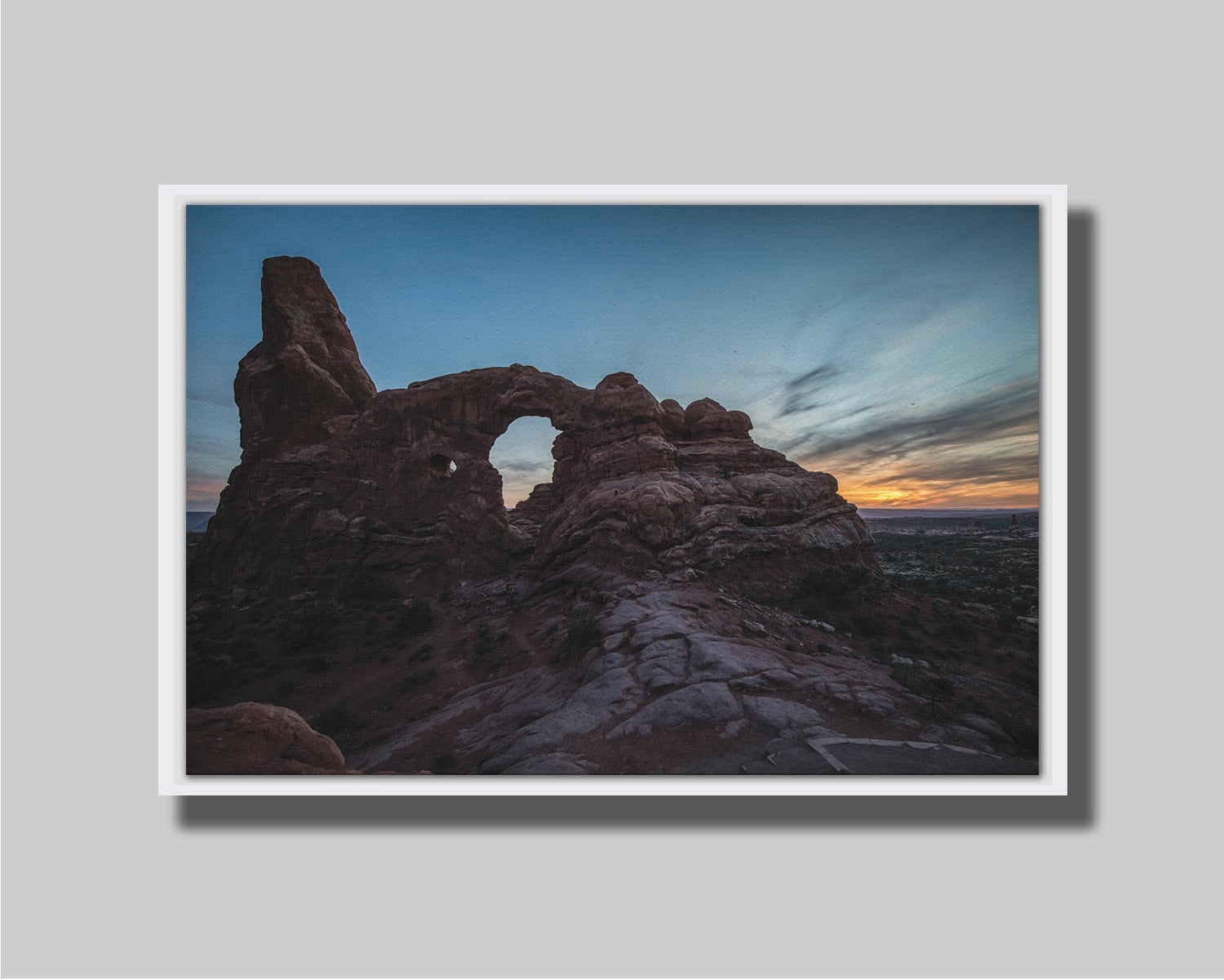 A photo of the Turret Arch rock formation at Arches National Park, Utah during sunset. Printed on canvas in a float frame.