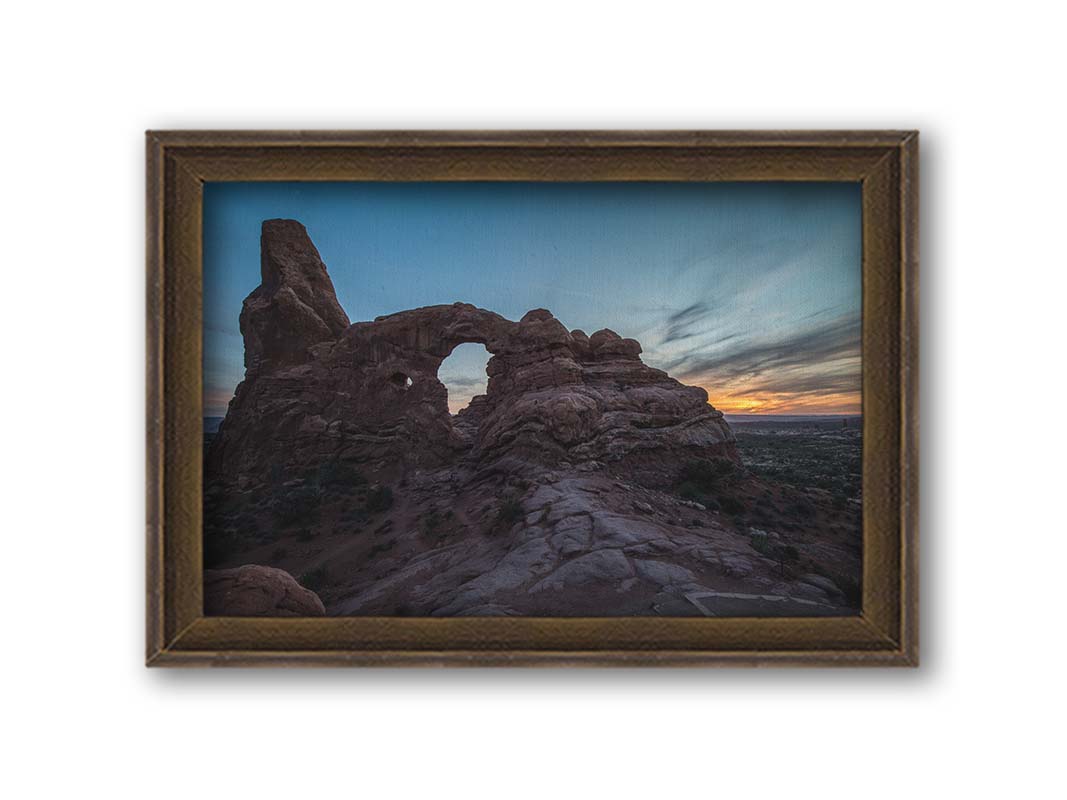 A photo of the Turret Arch rock formation at Arches National Park, Utah during sunset. Printed on canvas and framed.