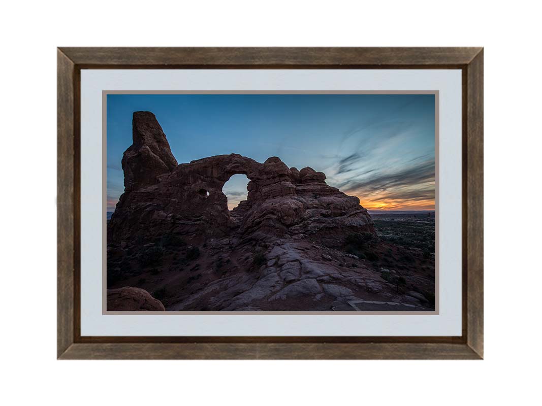 A photo of the Turret Arch rock formation at Arches National Park, Utah during sunset. Printed on paper, matted, and framed.