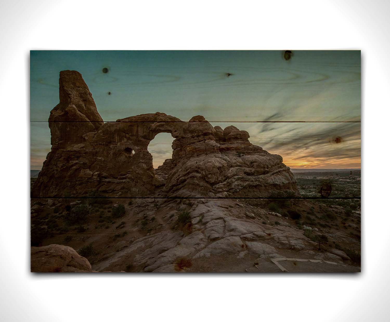 A photo of the Turret Arch rock formation at Arches National Park, Utah during sunset. Printed on a wood pallet.