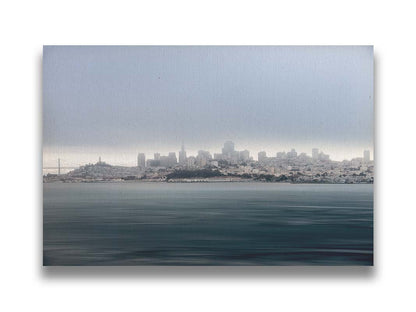 A photo of San Francisco bay taken from Vista Point. The long exposure of the photo creates a smoothing effect on the dark waters, and a heavy cloud of fog site just across the top of the city on the horizon. Printed on canvas.