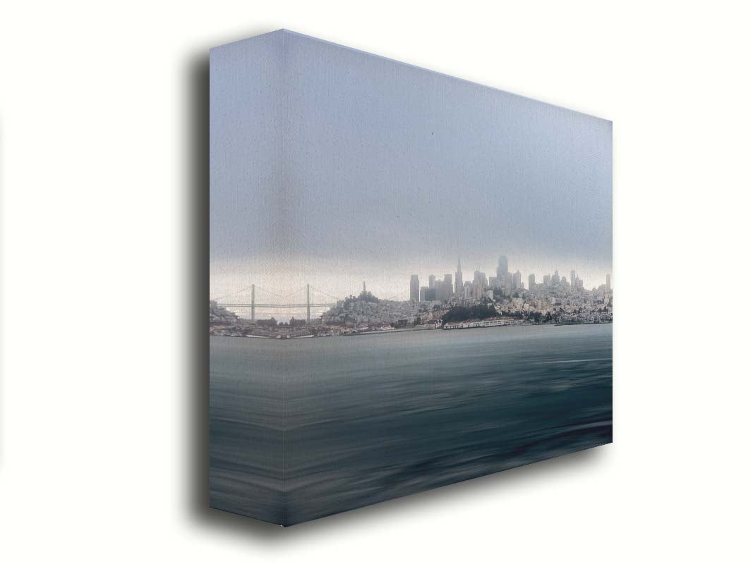 A photo of San Francisco bay taken from Vista Point. The long exposure of the photo creates a smoothing effect on the dark waters, and a heavy cloud of fog site just across the top of the city on the horizon. Printed on canvas.