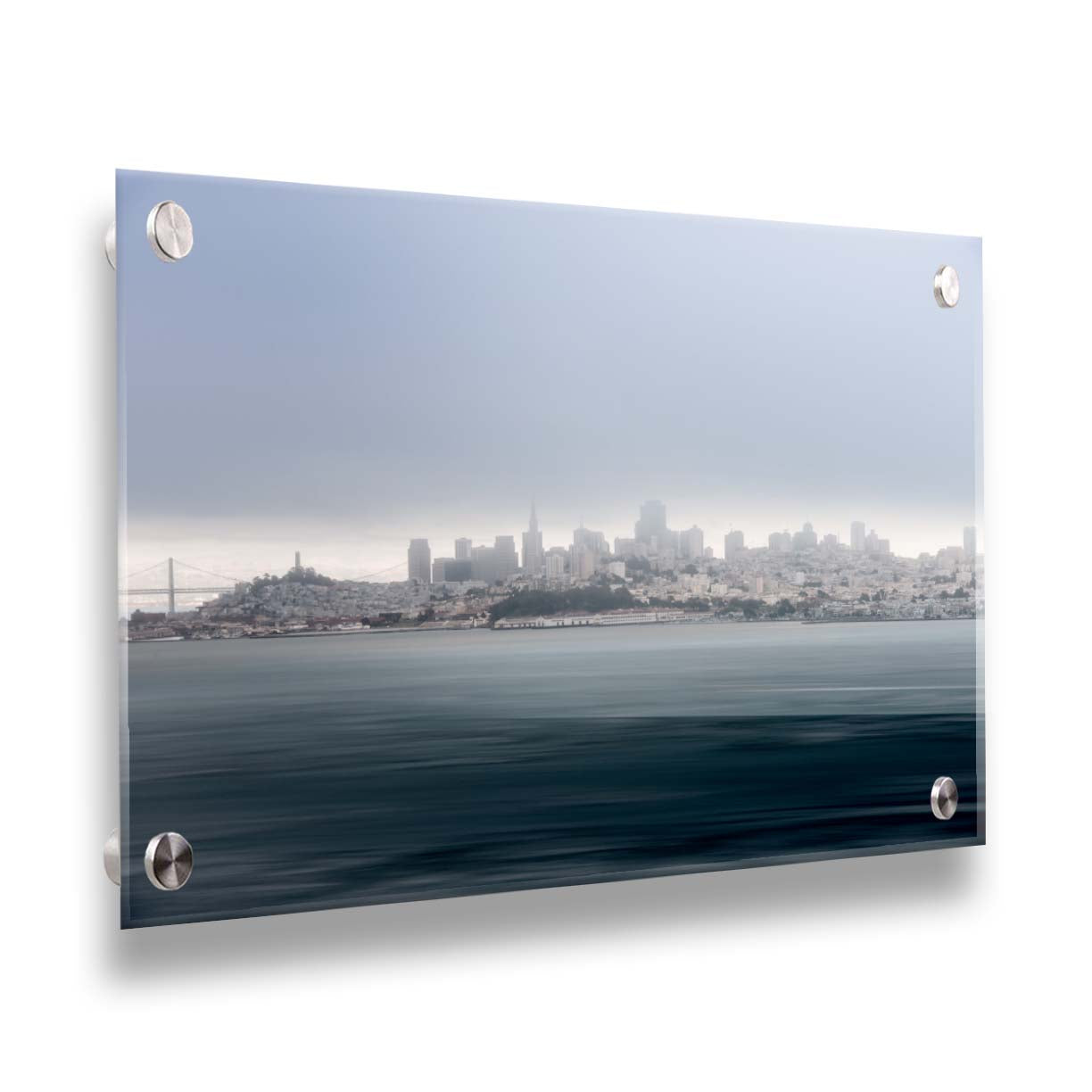 A photo of San Francisco bay taken from Vista Point. The long exposure of the photo creates a smoothing effect on the dark waters, and a heavy cloud of fog site just across the top of the city on the horizon. Printed on acrylic.